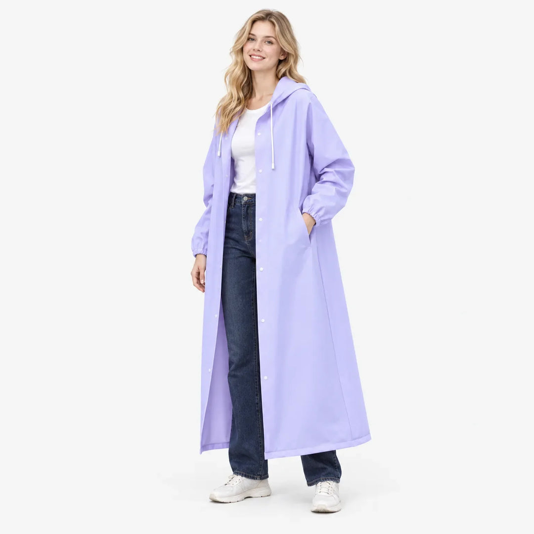 Smiling model in the lavender coat with one hand in a side pocket, worn over a white tee and jeans. 4