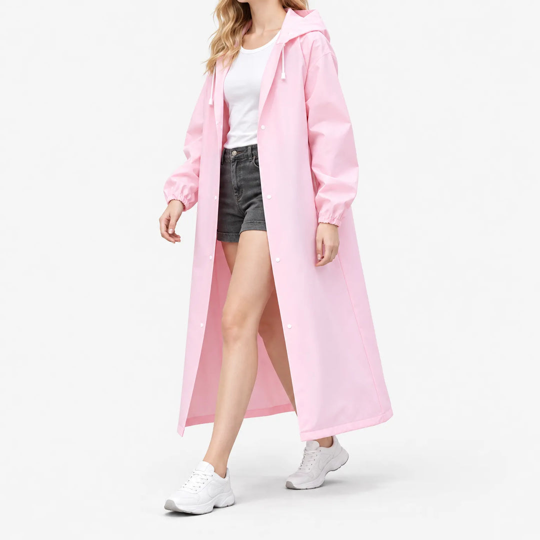 Side-angled studio shot of a model walking in the open pink coat, showing the long length and snap buttons. 5