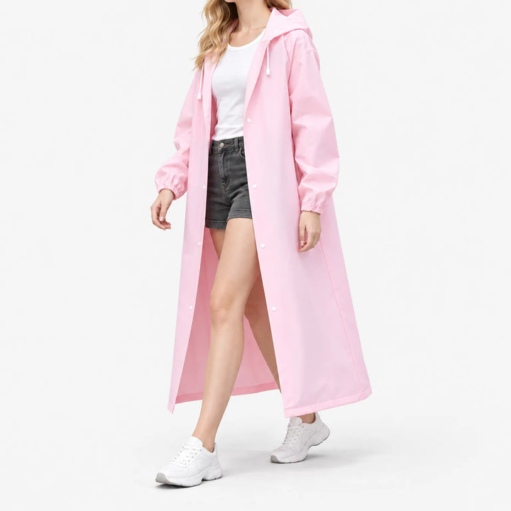 Side-angled studio shot of a model walking in the open pink coat, showing the long length and snap buttons. 5