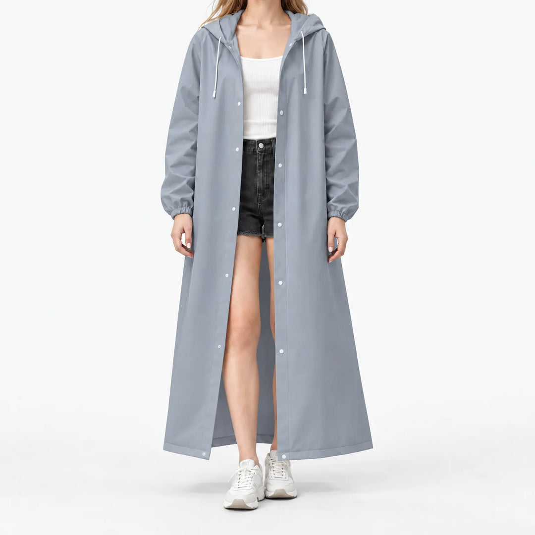 Studio front view of a model in the gray-blue hooded coat, open over shorts, showing drawcords and white snaps. 8