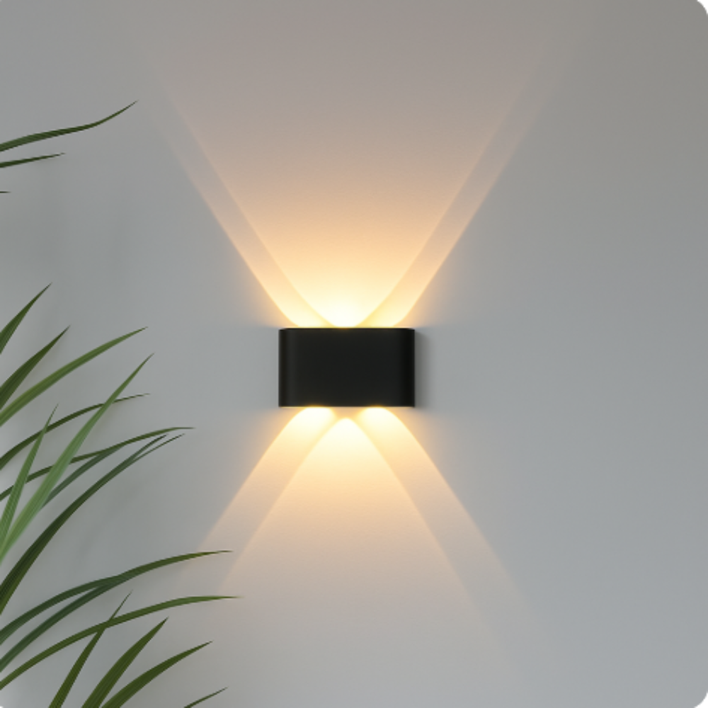 Black rounded-rectangle wall light detail with two openings, casting warm cone-shaped beams up and down a gray wall.