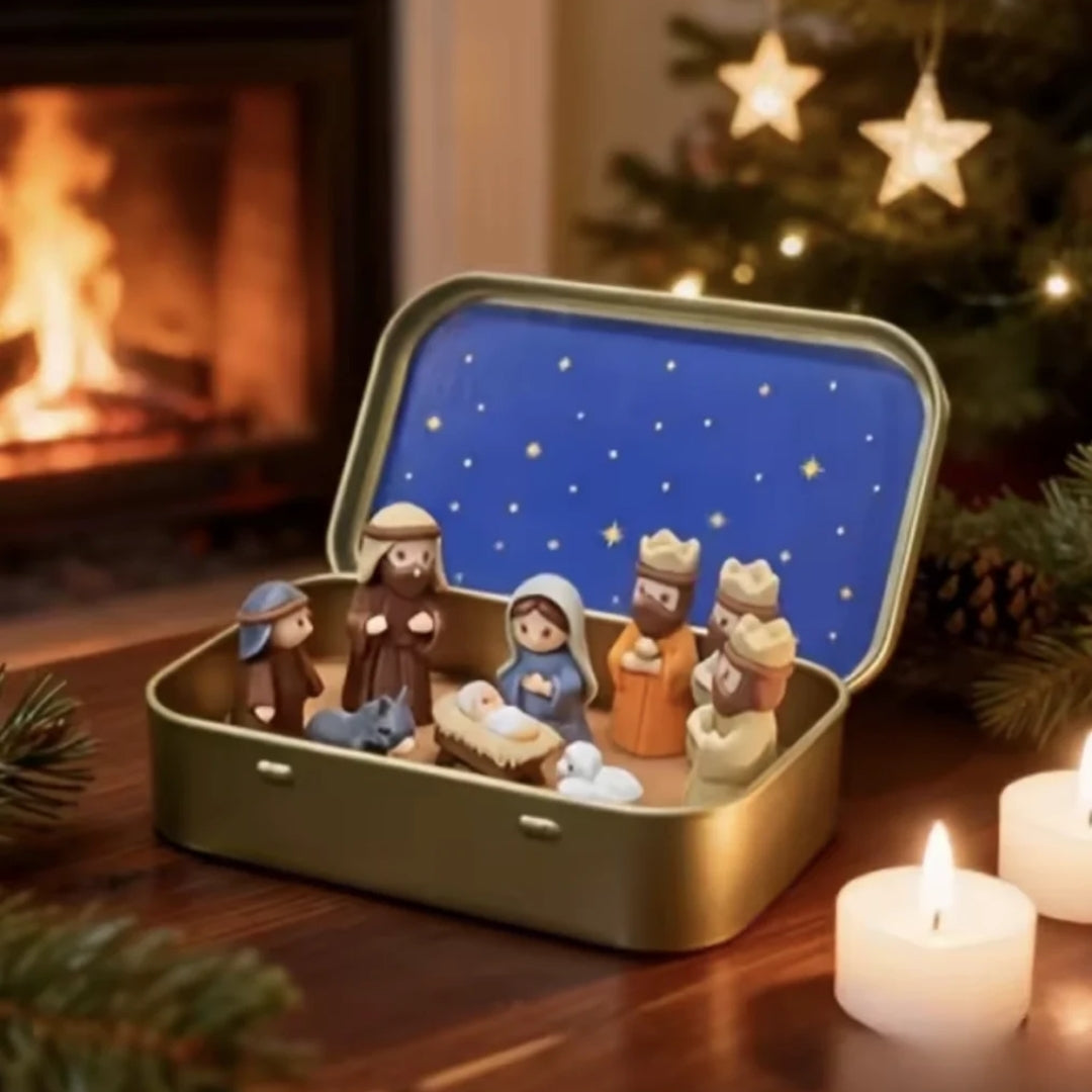 Open gold tin with nativity figures and a starry blue lid.