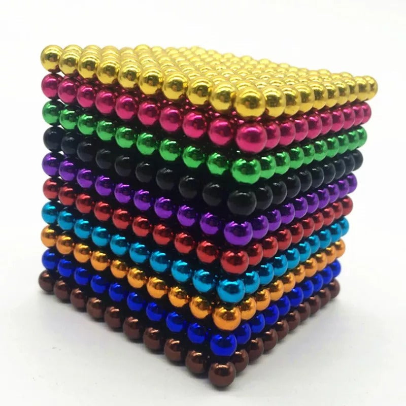 Large cube of shiny magnetic balls stacked in ten horizontal layers in different colors.