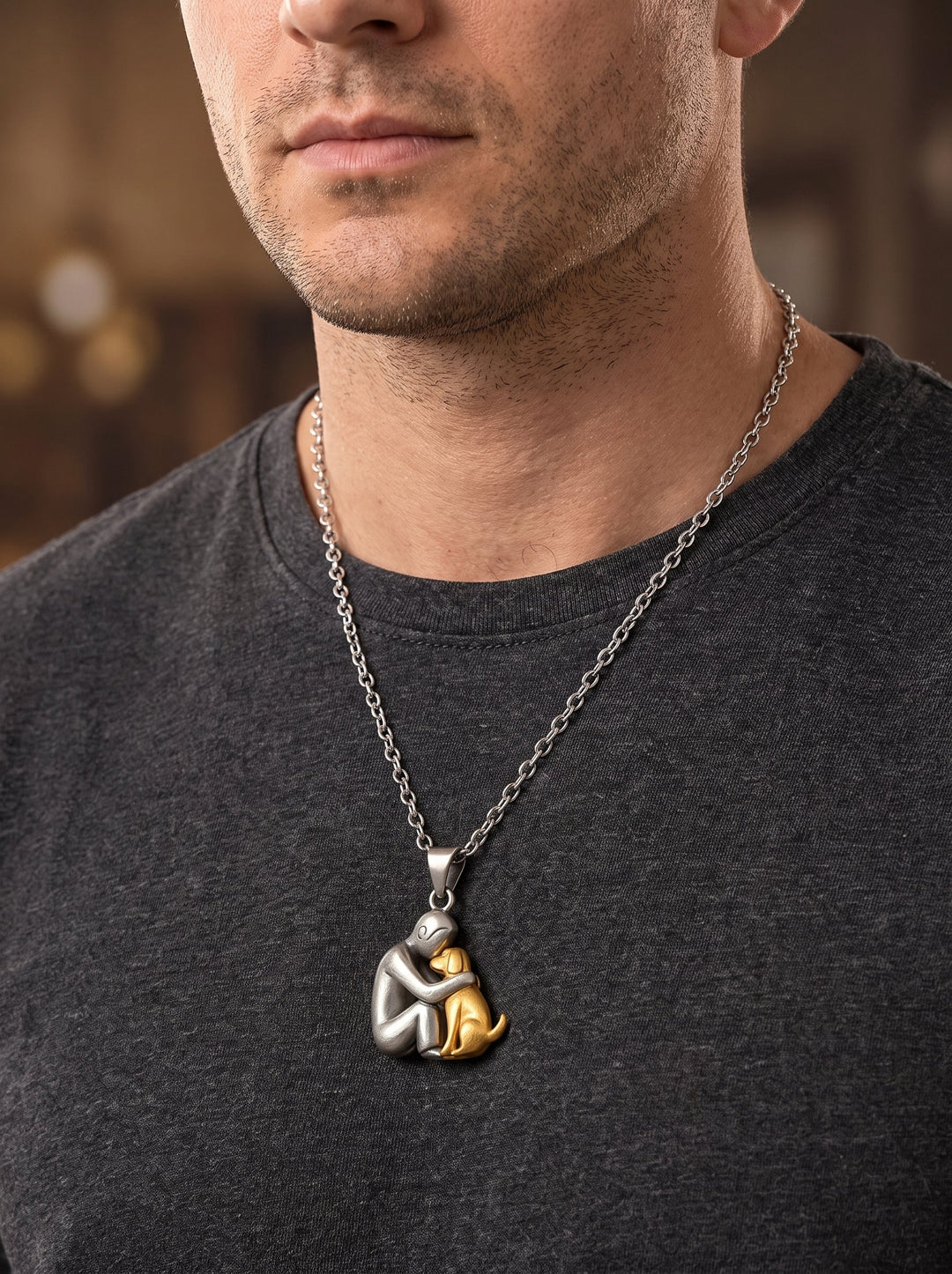 Man in a dark gray t-shirt wearing the matte silver-tone figure and gold-tone dog pendant on a longer chain. 11