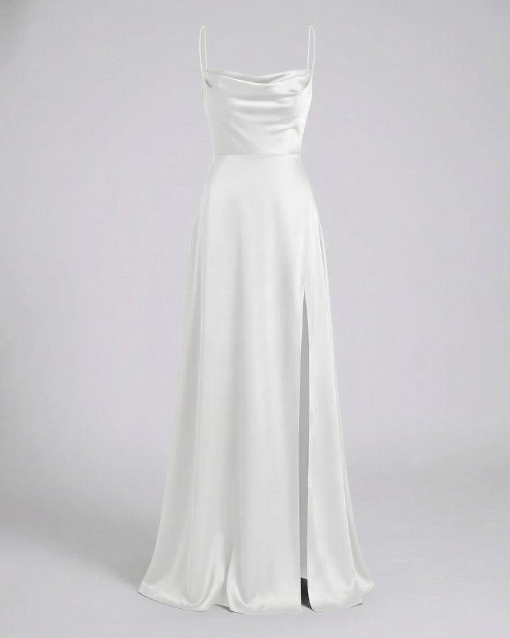White satin maxi dress shown flat, featuring a cowl neckline, thin straps, fitted waist and a high side slit.