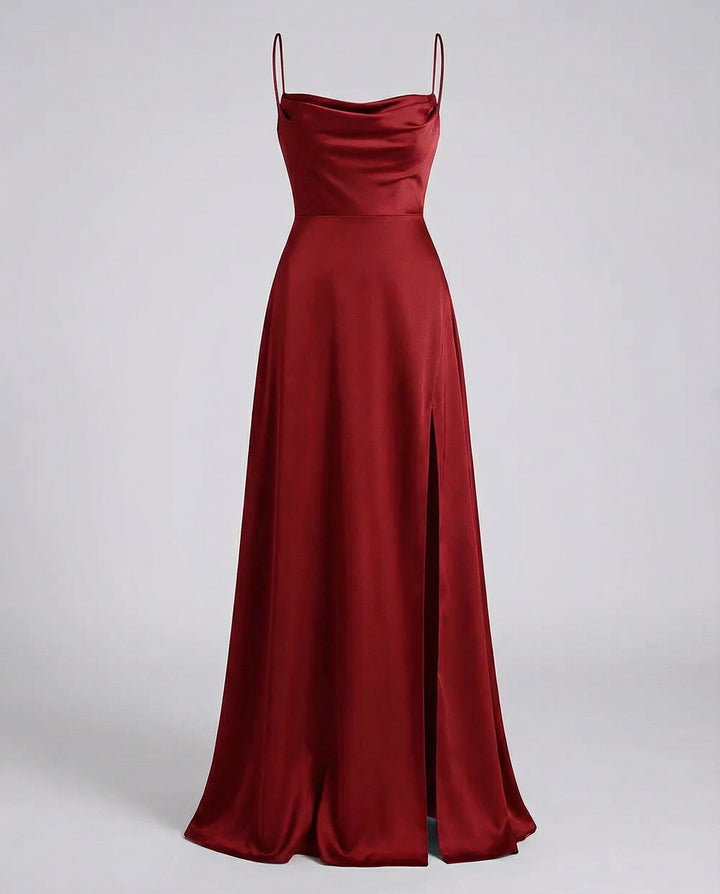 Red satin maxi dress shown flat, with cowl neckline, thin straps, fitted waist and side slit.