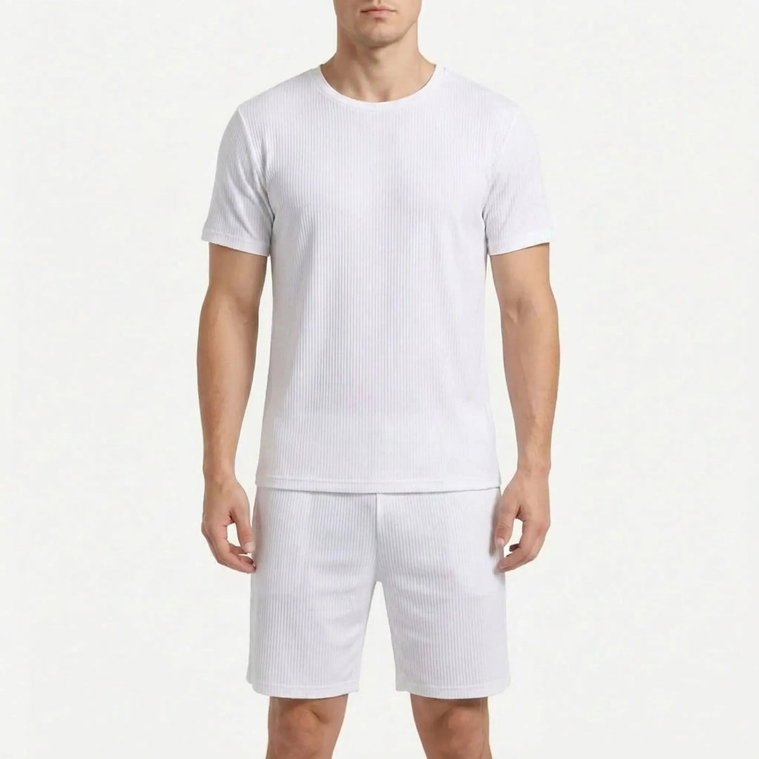 Man wearing the ribbed short-sleeve pajama tee and shorts in white, shown from the front on a white background. 9