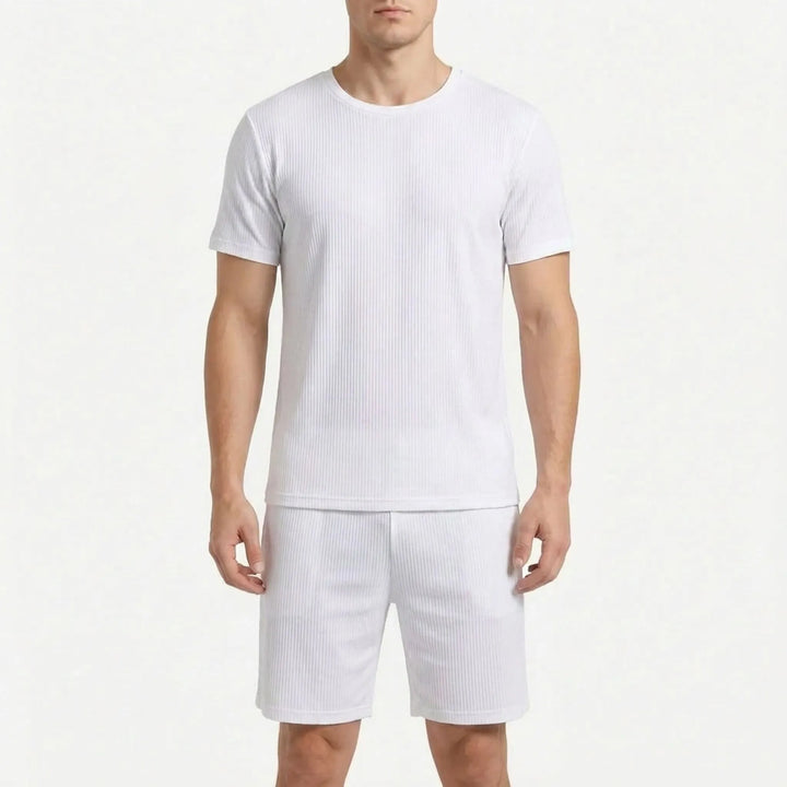 Man wearing the ribbed short-sleeve pajama tee and shorts in white, shown from the front on a white background. 9