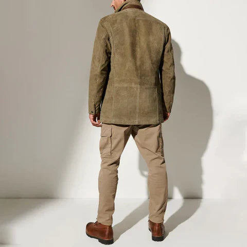 Back view of a man in the olive suede jacket with khaki cargo pants and brown boots 3