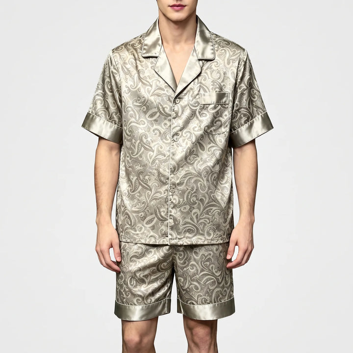 Front view of a model in the same paisley pajama set in a light grayish-green satin colorway. 5