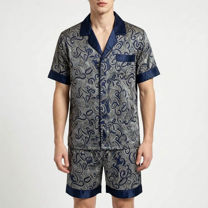 Front view of a model in the paisley pajama set in a navy and gray colorway with navy trim. 7