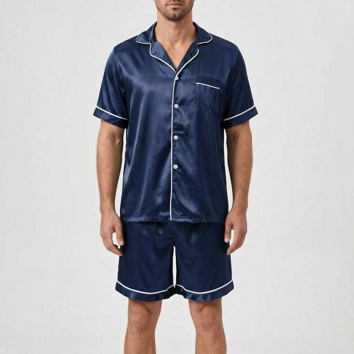 Model wearing the navy blue satin pajama set with white piping, white buttons, a chest pocket, and matching shorts. 10