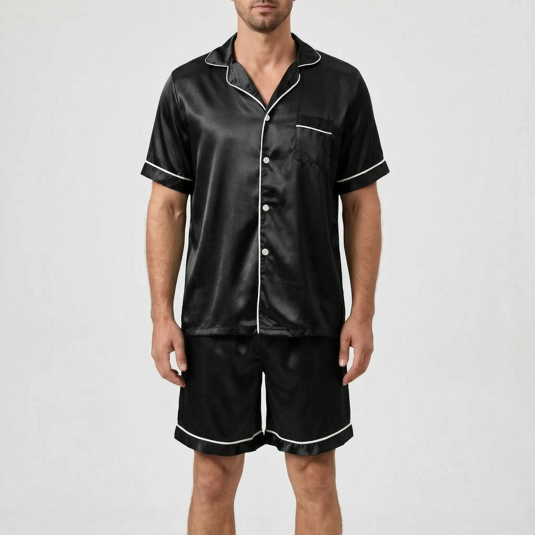 Model wearing the black satin pajama set with white contrast piping, light buttons, a chest pocket, and matching shorts. 9