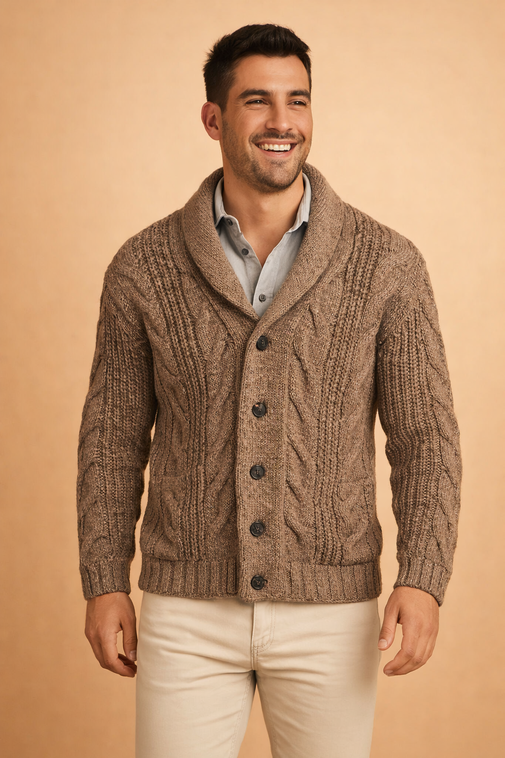 Close front view of the brown cardigan with chunky cables, ribbed hem and front pockets, worn by a smiling model 3