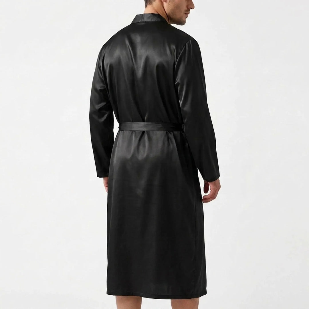 Back view of the black satin robe on a model, showing the smooth shoulders, long sleeves and belt tied at the waist. 3
