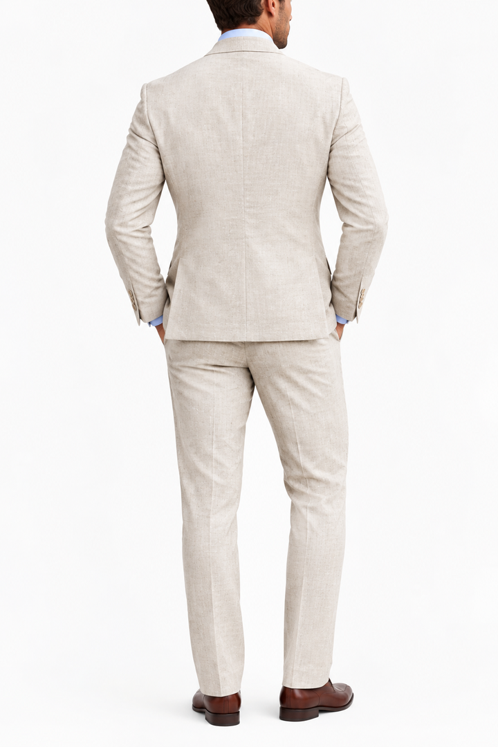 Back view of a beige suit jacket and matching trousers worn with brown leather shoes on white background 7