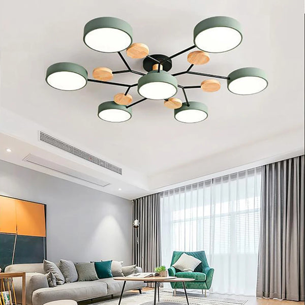 Green seven-disc ceiling light with black arms and wood accents above a living room sofa 2