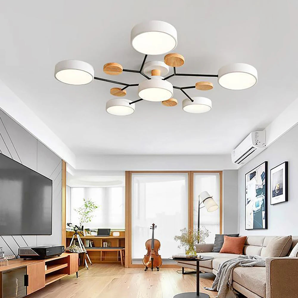 White ceiling light with six drum shades and wood discs in a bright living room 3