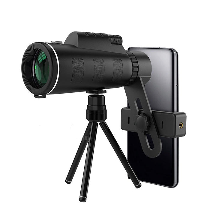 Monocular with green-coated lens on a compact black tripod with a phone holder clamp.