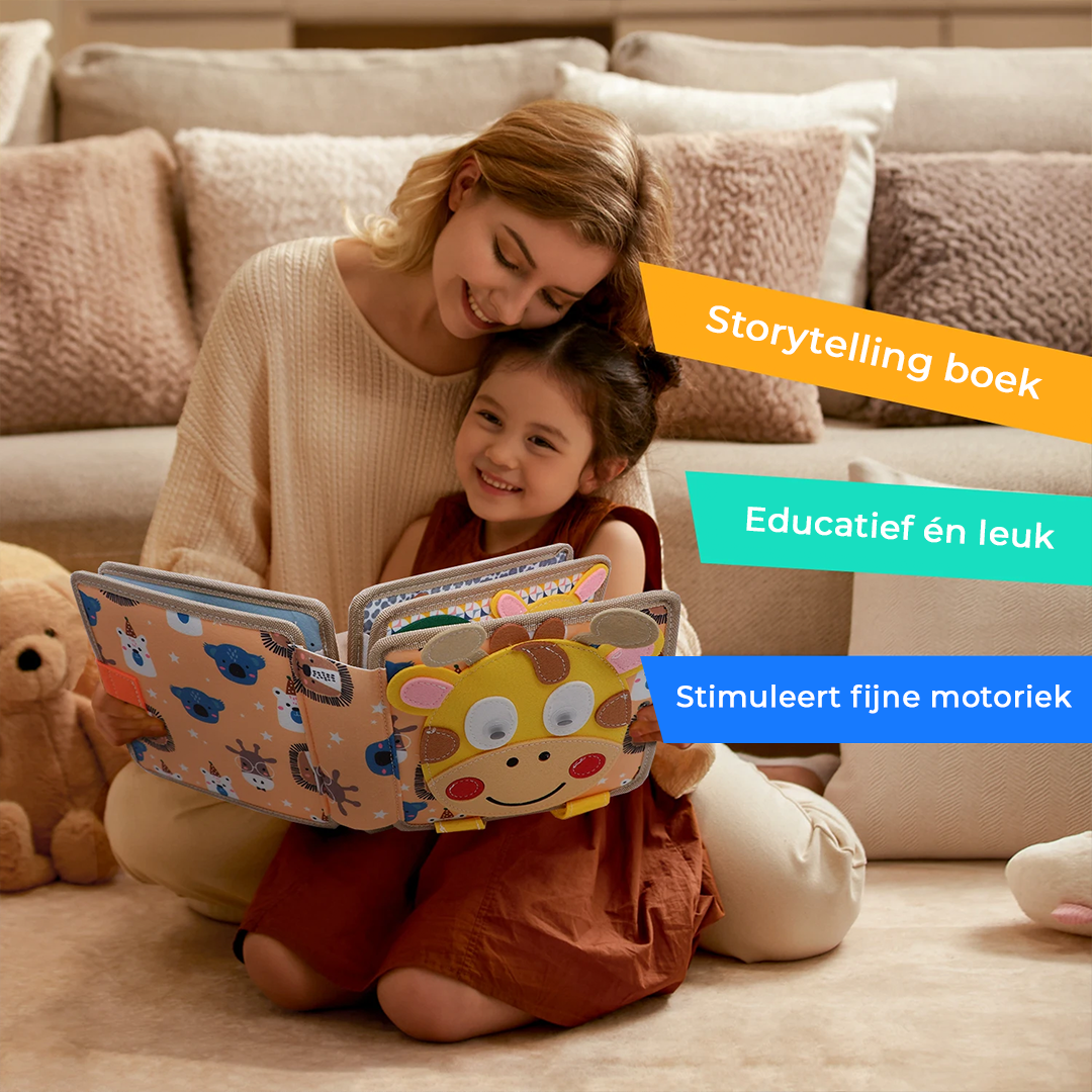 Smiling mother and young girl on the floor holding the open giraffe-cover felt book together.