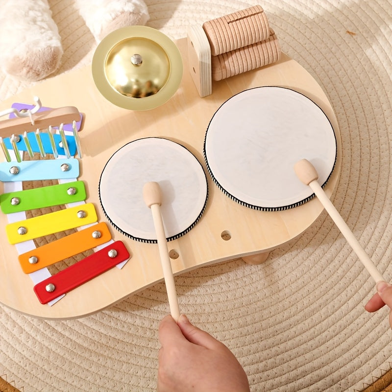 Close-up of hands striking the two white drum heads with wooden mallets.