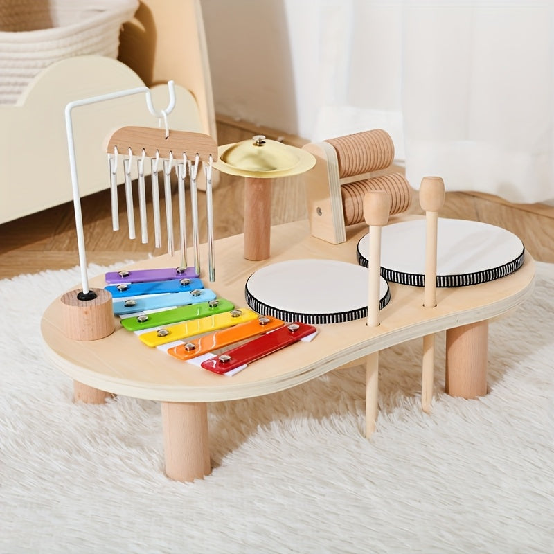 Wooden Montessori music table with mallets in their holders on a fluffy white rug.
