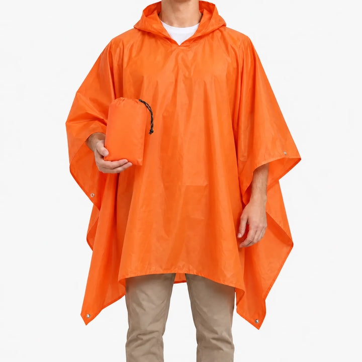 Man wearing the orange hooded poncho against a white background, holding the matching orange drawstring pouch it packs into. 2