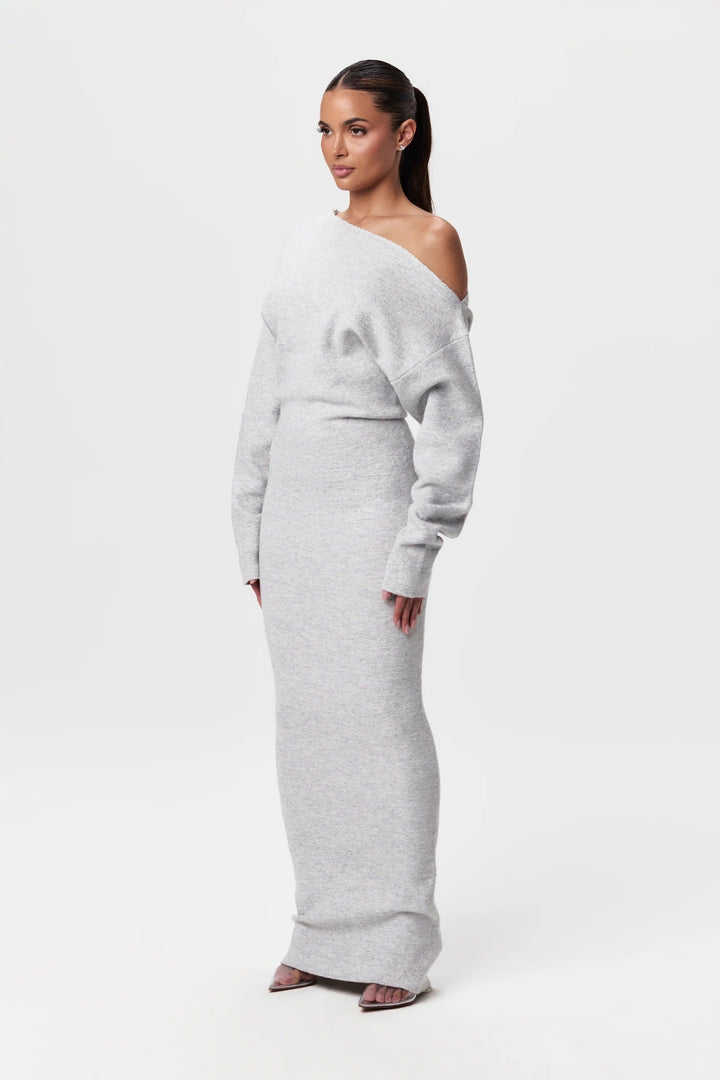 Angled view of the light gray knit maxi dress, showing the soft texture, slouchy sleeves and floor-length hem.