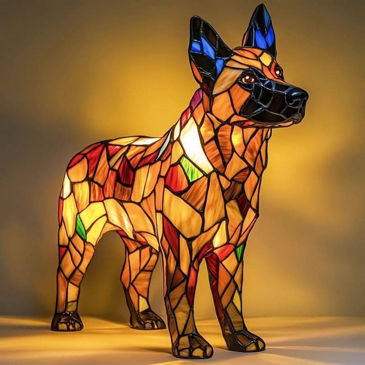 Standing shepherd-type dog lamp in amber and red mosaic panels with tall blue-tipped ears, lit from within against a golden background. 22
