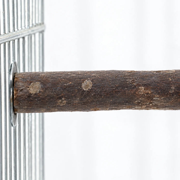 Close-up of the bark-covered branch perch where it is fastened to the metal cage bars with a round washer. 3