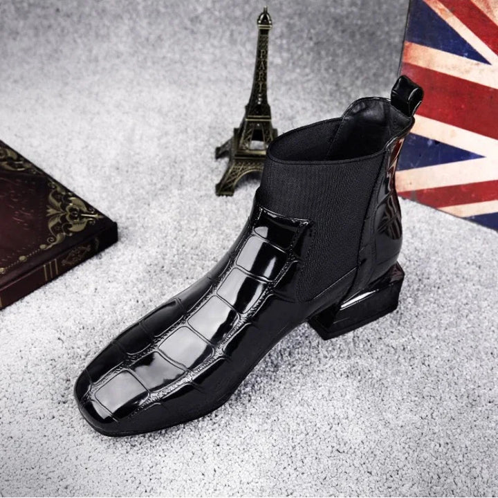 Black glossy croc-embossed ankle boot seen from above at a front angle, with elastic side panel 1