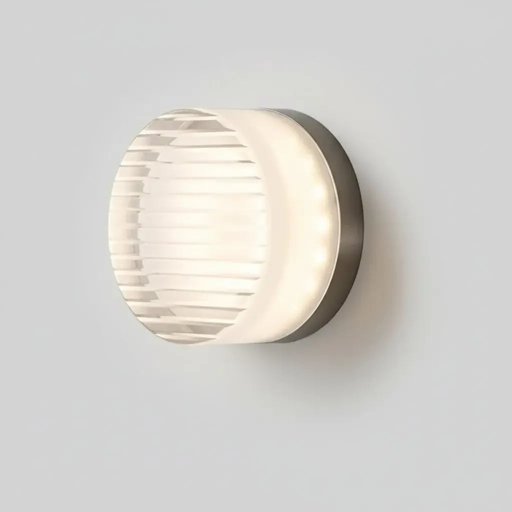 Lit round wall light with horizontal ribbed glass and visible LED dots along the side.