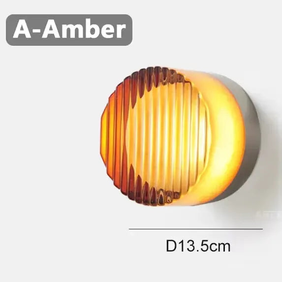 Amber glass round wall lamp with vertical ribbing and a 13.5 cm diameter dimension label.