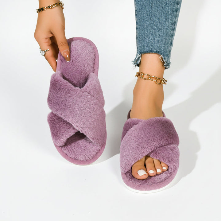 Purple fuzzy crossband slippers, one worn with ripped jeans and one held up showing the insole 8