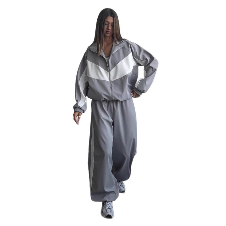 Women's windbreaker tracksuit set in gray and white, full-length front view on a plain white background.