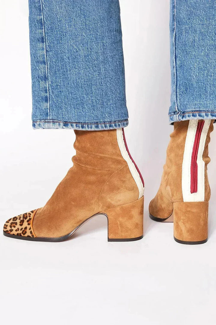 Tan leather heeled boots with leopard-print toe caps and block heel, back detail with cream panel and red zipper.