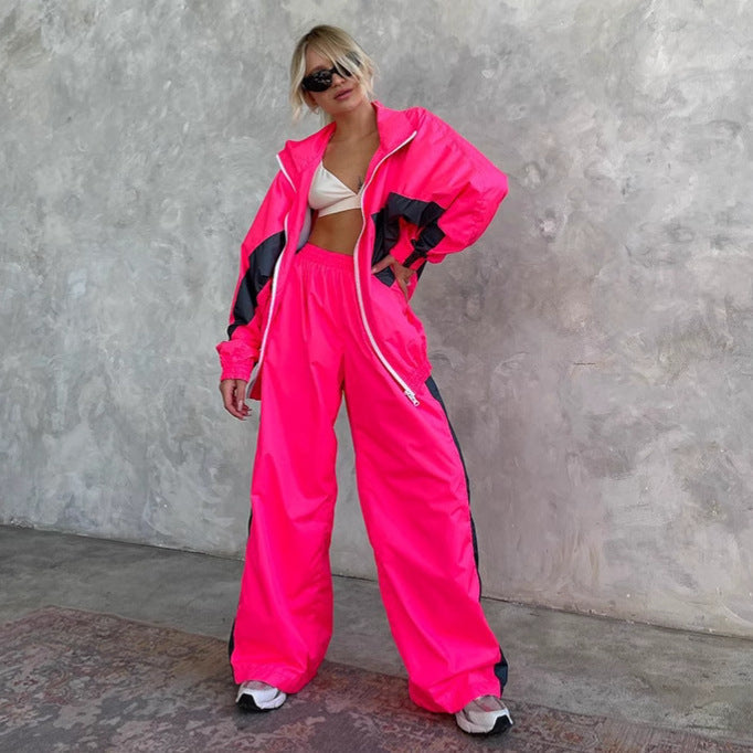 Women's windbreaker tracksuit set in hot pink and dark gray, another view with the jacket worn open.