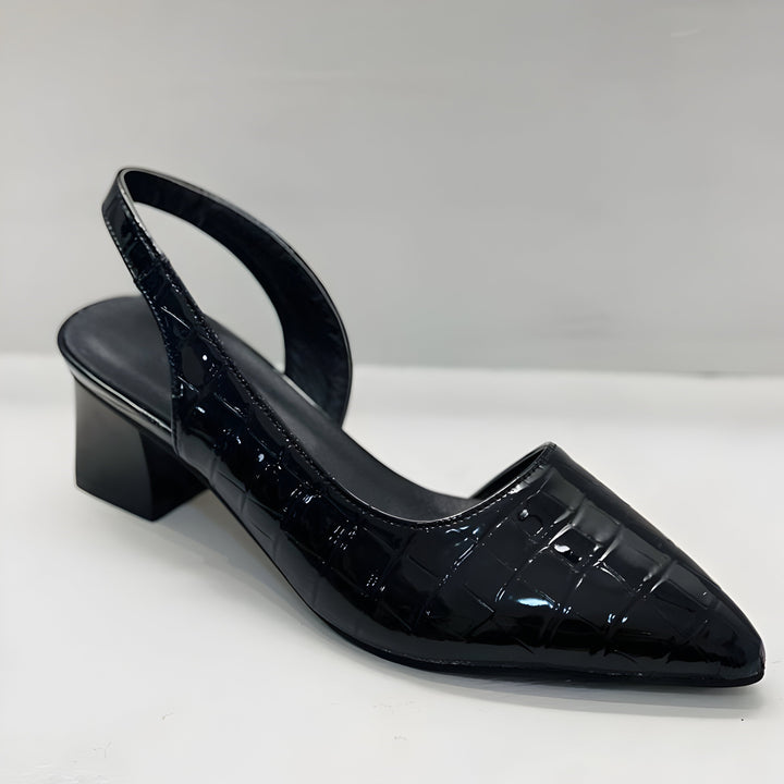 Single black patent croc-embossed slingback pump with pointed toe and block heel, seen from the front and side on a white surface. 4
