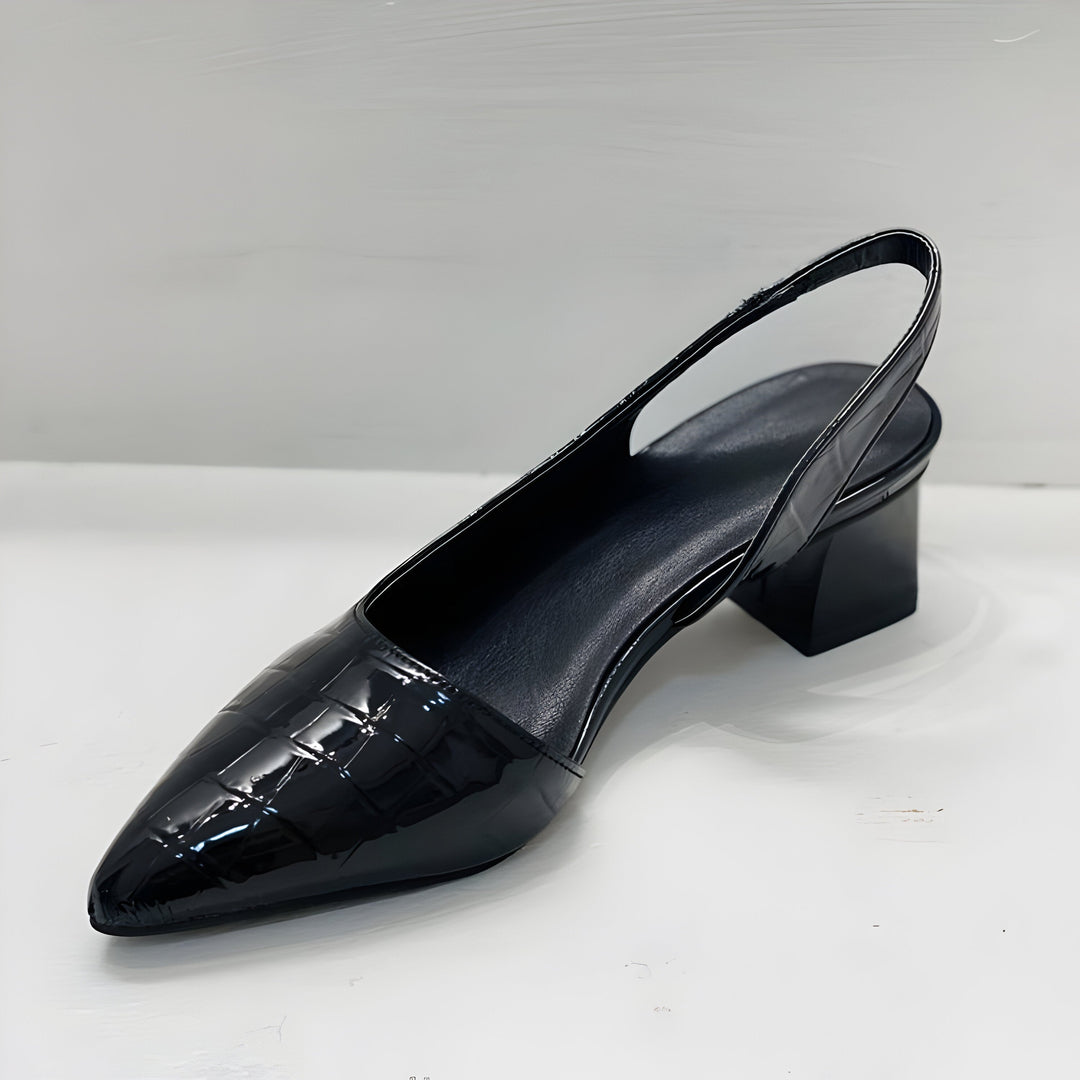 Black croc-embossed slingback pump photographed from above at an angle, showing the smooth padded insole, elastic back strap and low block heel. 5