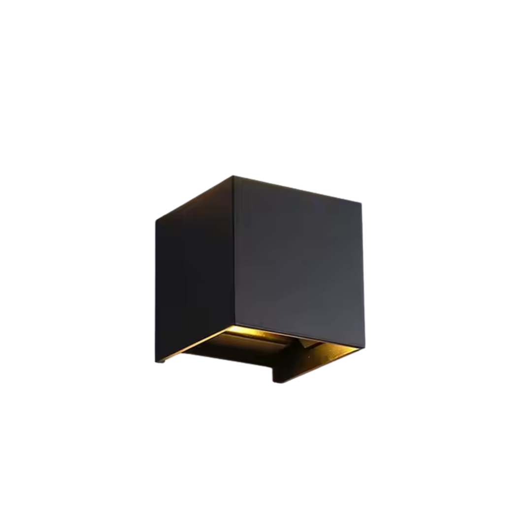 White square aluminium wall lamp on a white background, showing its square shape and warm glow.
