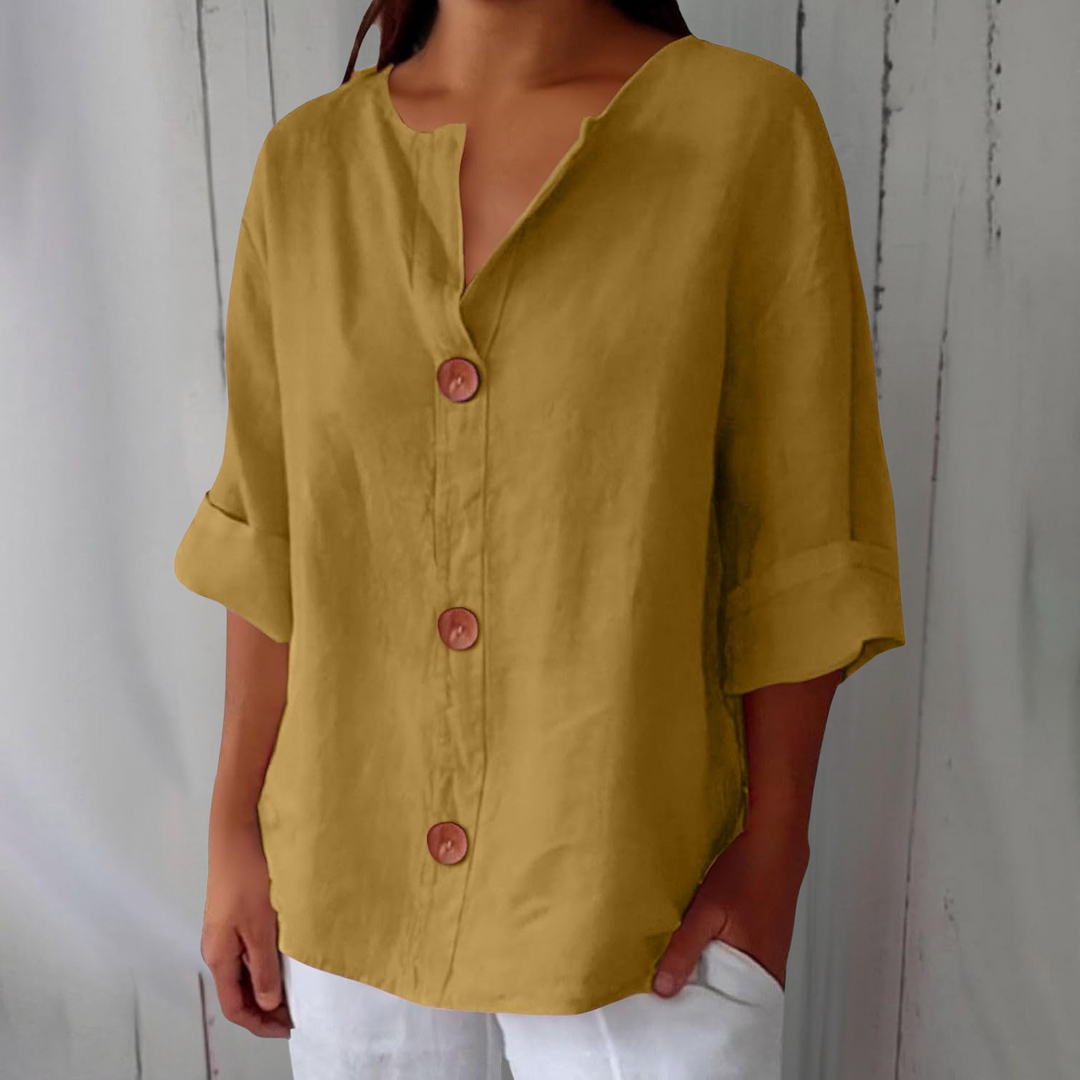 Olivia loose linen blouse in mustard yellow with a notched V-neck, three brown buttons and cuffed half sleeves.