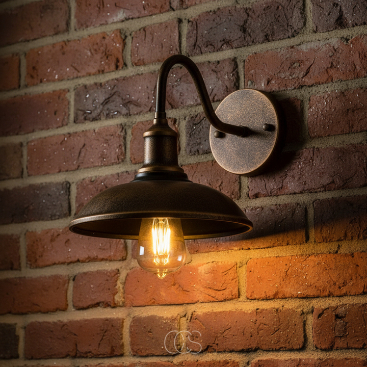 Vintage outdoor wall lamp in brown aluminium showing the curved arm and filament bulb