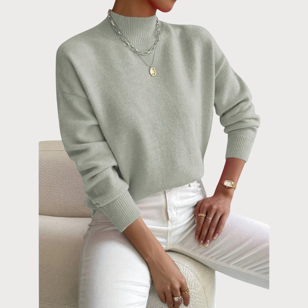 Women's sweater in sage green with a ribbed mock neck, dropped shoulders and ribbed cuffs.