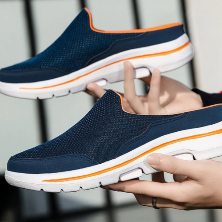 Orthofit 2.0 sport sandals in navy with orange trim, pair held at eye level.