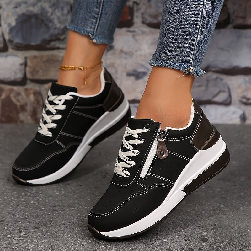 Black wedge sneakers with white stitching, laces and side zipper