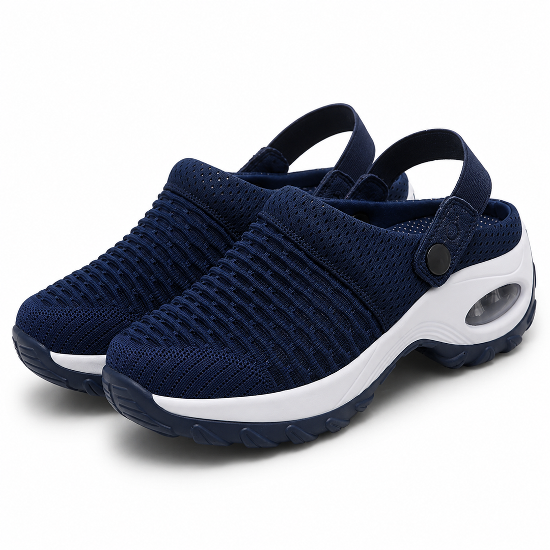 Pair of navy blue knit mesh clogs with ribbed texture, a white air-cushion midsole and snap heel straps on a white background.