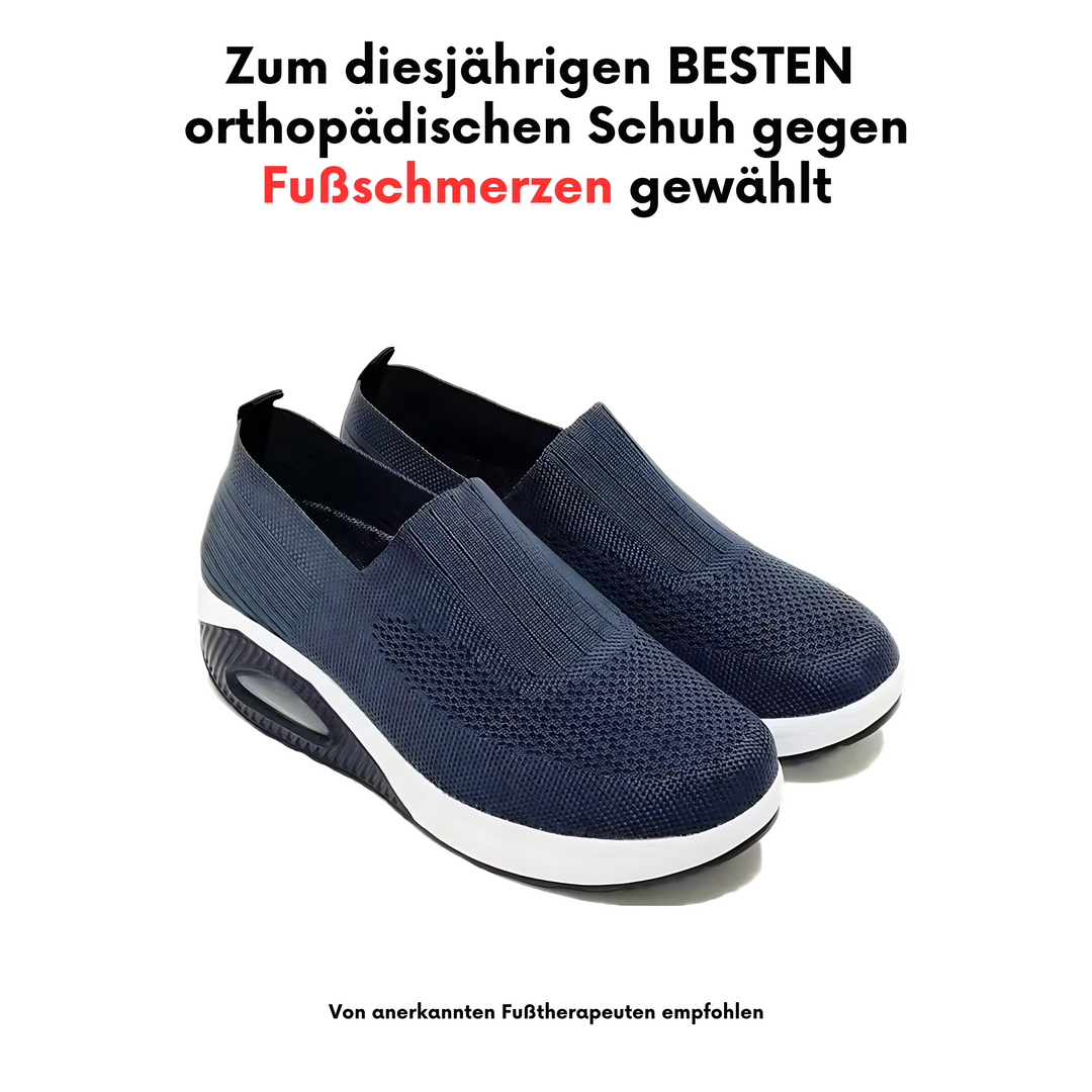Pair of navy blue knit slip-on shoes with a white sole and air cushion on a white background.