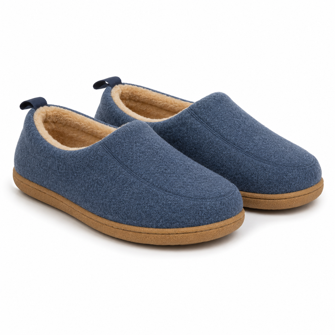 Pair of navy blue felt slippers with cream fleece lining and tan sole, shown at an angle.