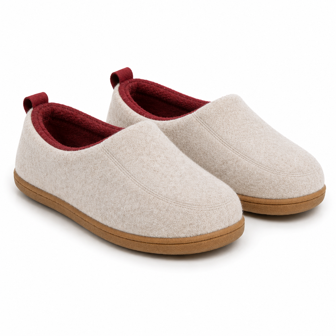 Pair of beige felt slippers with deep red lining and red heel pull tabs on tan rubber soles.