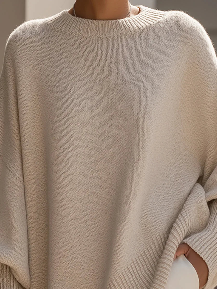 Close-up of the beige sweater's ribbed crew neckline and soft knit texture on the chest and shoulders 2